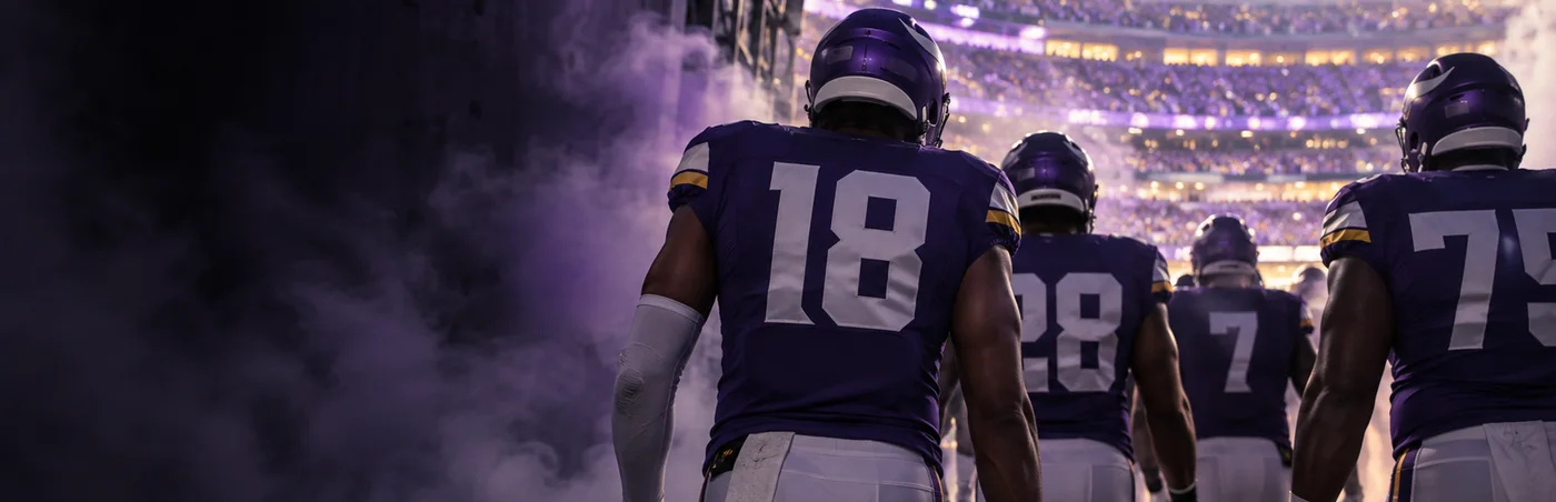 Players walking out of the tunnel toward a full stadium bowl before kickoff