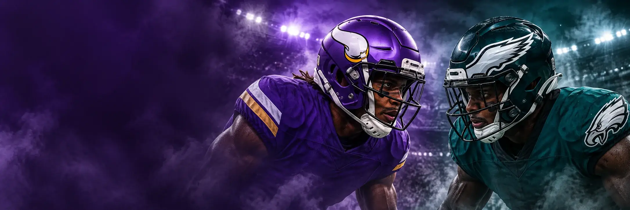A Vikings player and an Eagles player face off helmet to helmet under stadium lights