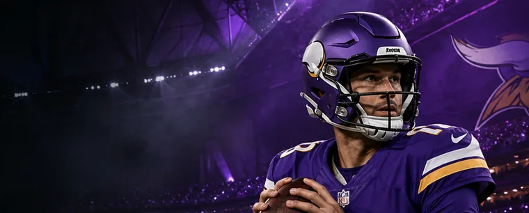A Vikings quarterback in the pocket during a night game